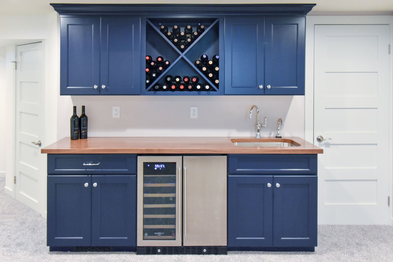 basement bar remodel with navy cabinets