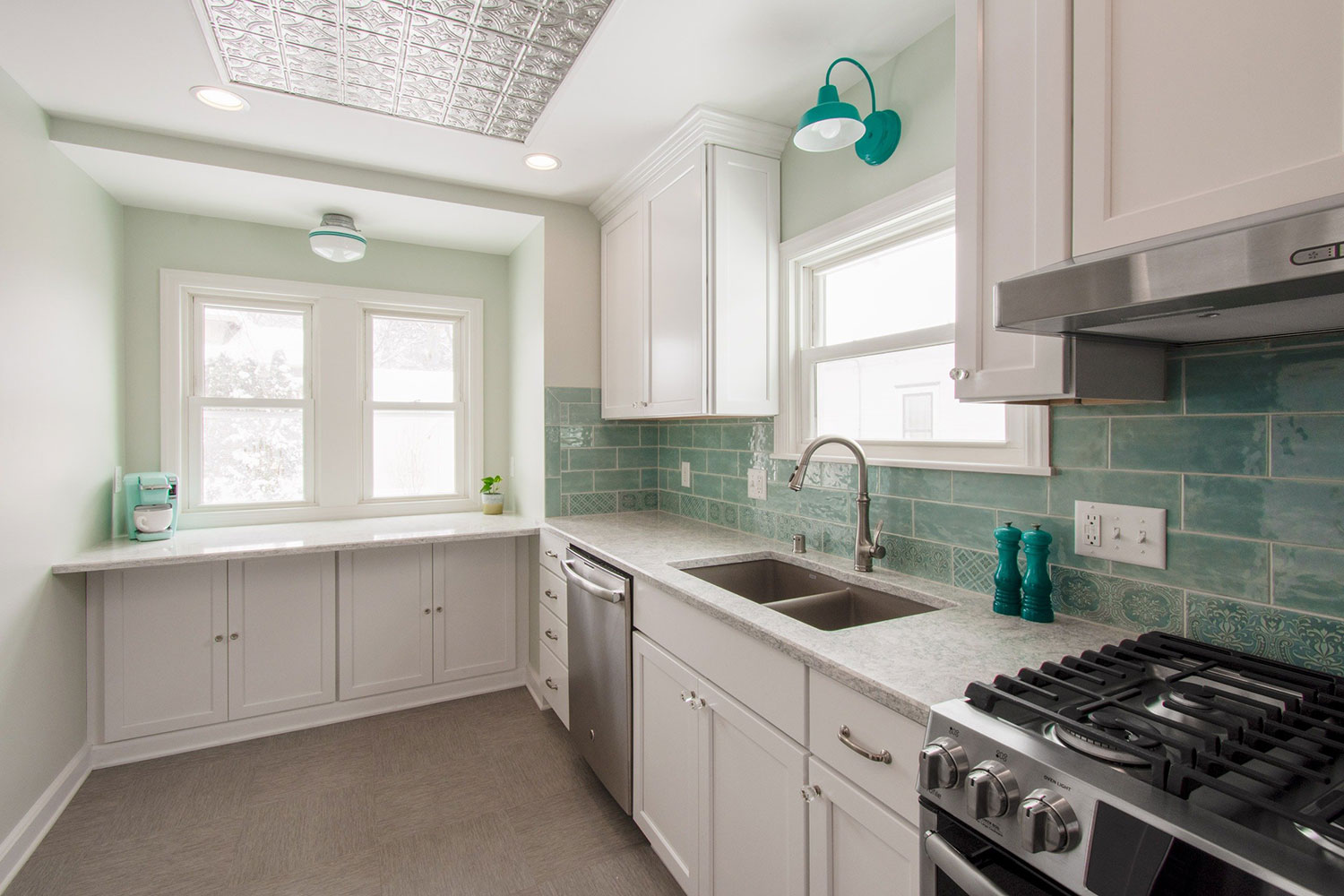 Wauwatosa kitchen with teal subway tile backsplash and a tin ceiling